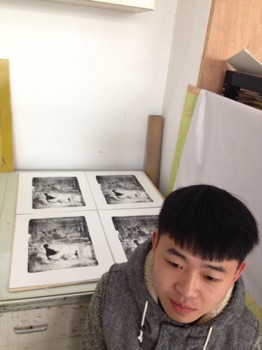 Yi Jun He with his prints